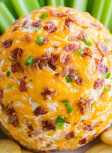 Delicious Bacon Ranch Cheeseball with bacon, herbs, and spices on a serving platter.
