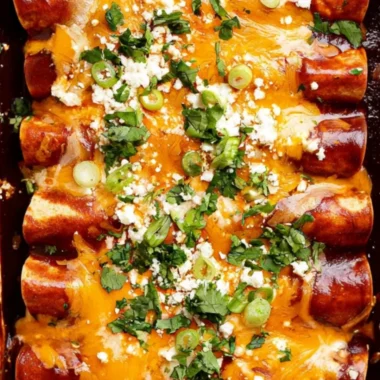 Cozy black bean enchiladas topped with cheese and garnished with cilantro