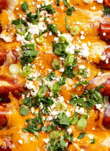 Cozy black bean enchiladas topped with cheese and garnished with cilantro