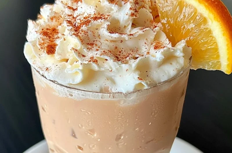 Creamy and aromatic cozy orange cinnamon milk tea in a cup
