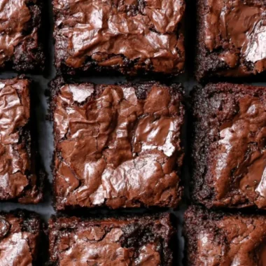 Decadent fudgiest brownies in a cozy setting, perfect for chocolate lovers.