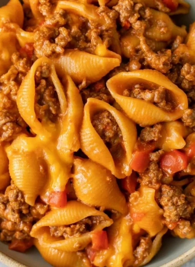 High protein taco pasta dish garnished with fresh ingredients and served in a bowl.