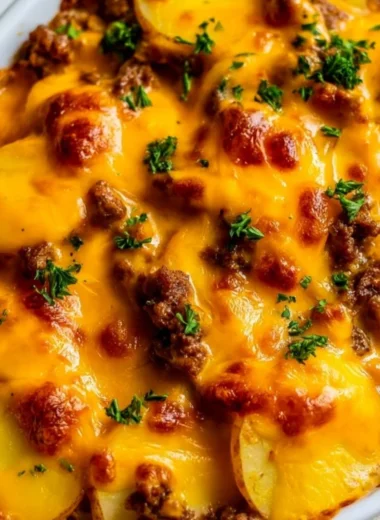 Hobo Casserole dish with layers of meat, potatoes, and vegetables
